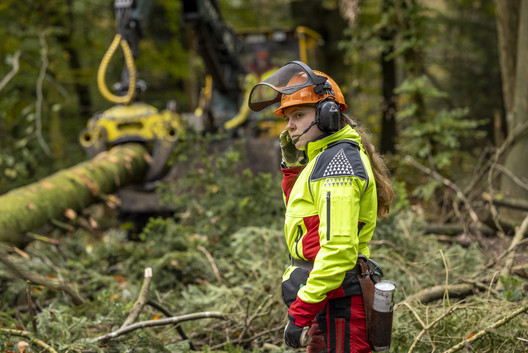 Forstwirtin überwacht Holztransport aus dem Wald